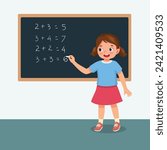 Cute little girl student writing with chalk math equation on the blackboard in front of class