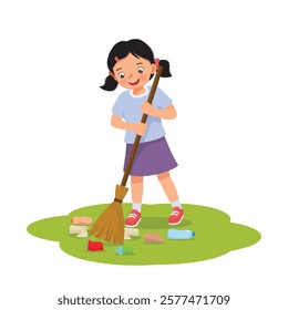 Cute little girl sweeping trash in the yard with broom