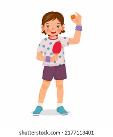 Cute little girl table tennis player holding ping pong ball with paddle ready to play