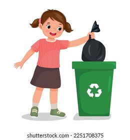 cute little girl taking out the trash in garbage bag into recycling bin doing daily routine housework chores at home