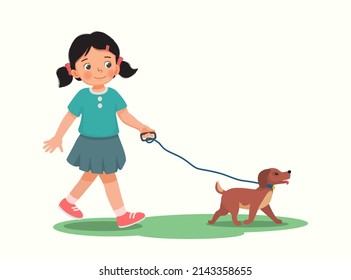 Cute little girl walking the dog in the park 