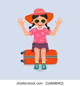 cute little girl wear hat and sun glasses sitting on suitcase excited going for travelling on summer vacation waving hand