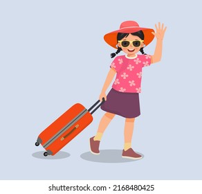 linda niña usa sombrero y lentes de sol tirando de la maleta y saludando a la mano para viajar en vacaciones de verano