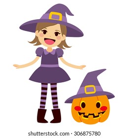 Cute little girl wearing purple witch Halloween costume and mascot pumpkin with witch hat