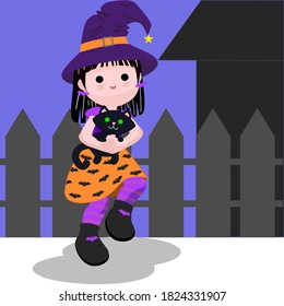 Cute little girl in witch costume with a black cat in arms