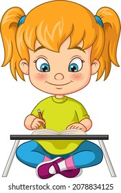 Cute little girl writing on book