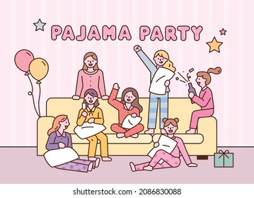 Cute little girls are having a pajama party while sitting around the sofa. flat design style vector illustration.