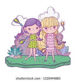 cute little girls playing maracas in the landscape
