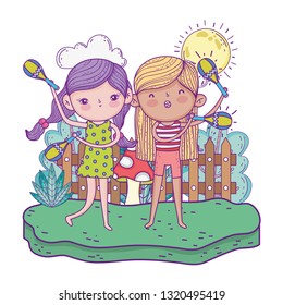 cute little girls playing maracas in the landscape