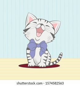 Cute little gray kitten sitting on a rug on a background of blue wallpaper 