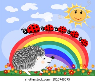 A cute little hedgehog near the seven-colored rainbow and a family of ladybirds in a clear, sunny cheer, a summer day