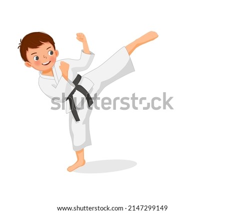 cute little karate kid boy with black belt showing kicking attack techniques poses in martial art training practice