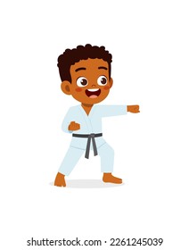 cute little kid training and showing karate pose