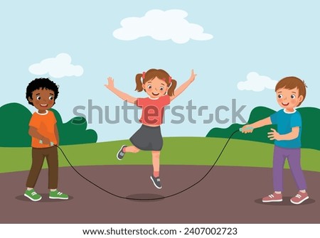 Cute little kids playing jumping rope at the park