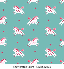 Cute little ponies seamless vector pattern.  White hand-drawn horses with red tails and manes on a bright blue background. Red apples as decorative polka dot elements.