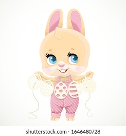 Cute little rabbit in striped jumpsuit holds a paper garland with Easter eggs cut out of paper  isolated on white background