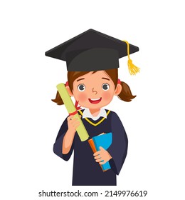 cute little schoolgirl in graduation hat and gown holding books and diploma certificate