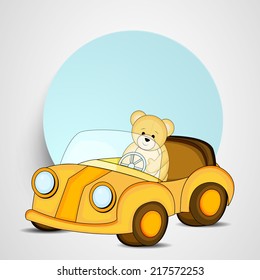 Cute little teddy year driving toy car with blank sticky on grey background.