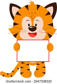 A cute little tiger cub is standing with a postcard. Tableau for text, congratulations. The Year of the Tiger. Happy New Year and Merry Christmas. The new year is 2022.