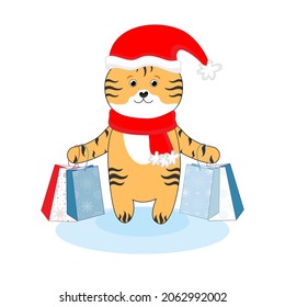 Cute little tiger on a white background in a Christmas hat with gift bags. The symbol of the new year 2022. Chinese Tiger New Year.