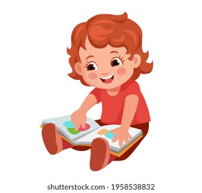 cute little toddler sitting on floor and enjoying bright pictures in children's book. Books for little ones.