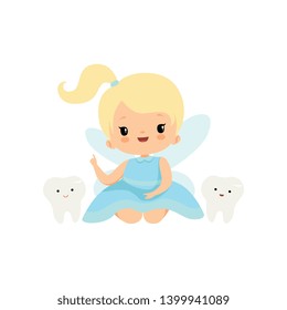 Cute Little Tooth Fairy with Baby Teeth, Lovely Blonde Fairy Girl Cartoon Character in Light Blue Dress with Wings Pointing Finger Up Vector Illustration