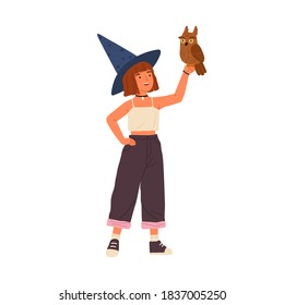 Cute little wizard holding magical owl vector flat illustration. Smiling female child demonstrating fairy animal isolated on white. Happy girl sorcerer wearing witch hat standing with magic bird