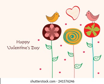 Cute love birds sitting on creative flowers with heart shape for Happy Valentine's Day celebrations.
