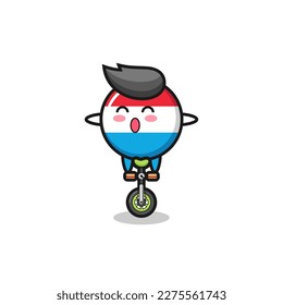 The cute luxembourg flag badge character is riding a circus bike , cute style design for t shirt, sticker, logo element