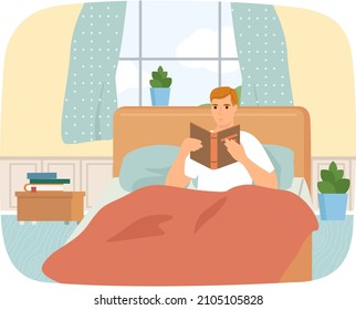 Cute man in pajamas reading literature on his bed comfortably. Book lover concept with young man lying relax on sofa and reading book. Concept of homeward and comfort. Person relaxes after work