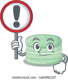 cute mascot character style of pistachio macaron raised up a sign