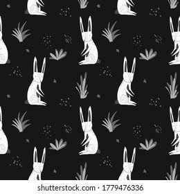 Cute monochrome dark seamless pattern with white cartoon rabbits, gray grass and dots. Funny hand drawn texture with hare and herbs for kids design, wallpaper, textile, wrapping paper