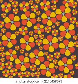 Cute motley floral seamless pattern. Orange-yellow abstract flowers of different sizes are randomly arranged on a black background. Vector.