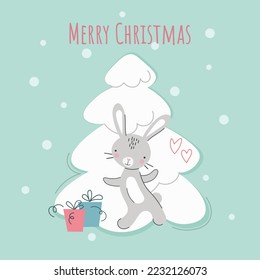 Cute New Year's rabbit near a white Christmas tree with gifts. Chinese character for 2023. Symbol of the year. Vector cartoon. Cartoon flat style. Lettering Merry Christmas.