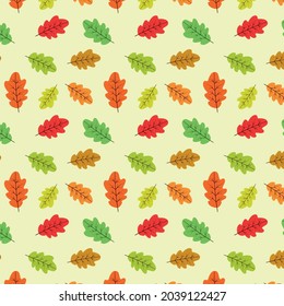 Cute oak leaves seamless pattern in red, green and orange on light cream background. Great for Thanksgiving greeting cards,  textile , posters,  website background and gift wrapping paper 