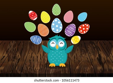 A cute owl has a happy smile and turns many colorful Easter eggs. Greeting card for the holiday. A blank space for your text or advertising. Vector on wooden background.