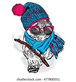 Cute owl wearing a hat and scarf. Vector illustration for greeting card, poster, or print on clothes. Autumn or winter.