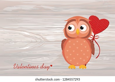 Cute owlet waiting to give heart a gift for Valentine's Day. Greeting card. Empty space for your text or advertisement. Vetornaya illustration on a wooden background