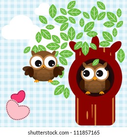 Cute owls couple on the tree branch