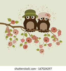 Cute owls on branch