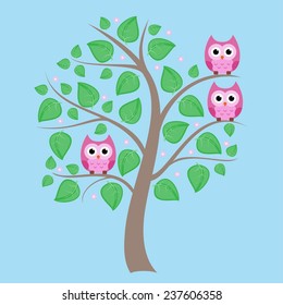 Cute owls sitting on the spring tree
