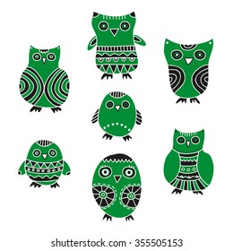 Cute Owls vector illustration. Set of cartoon green and black owls and owlets on a white background