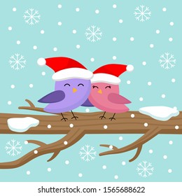 Cute pair of birds sitting on tree in winter.