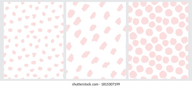 Cute Pastel Color Geometric Seamless Vector Patterns. Light Pink Hand Drawn Polka Dots and Spots on a White Background. Lovely Infantile Irregular Doodle Print.