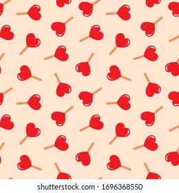 Cute pattern. Illustration of red lolly pops drawn in flat style on a light brown background. Vector 8 EPS.