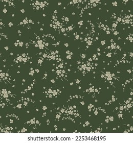 Cute pattern in a small flower. Small light green flowers. Dark green background. Fancy floral background. An elegant template for fashionable prints.