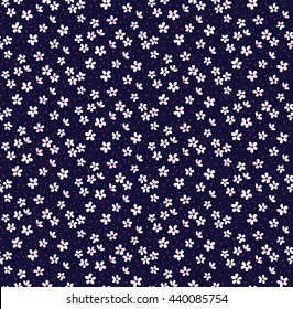 Cute pattern in small flower. Small white flowers. Dark blue background. Ditsy floral background. The elegant the template for fashion prints.