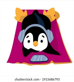
A cute penguin lies on the beach. Penguin listens to music with headphones.