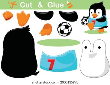 Cute penguin playing soccer. Education paper game for children. Cutout and gluing. Vector cartoon illustration
