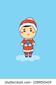 A cute picture of a boy in a Santa suit with a gift in his hands on a blue background. A Christmas card with a toddler